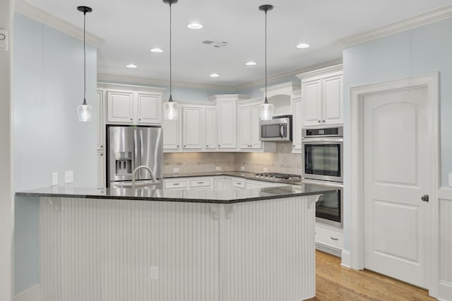 kitchen with a peninsula, dark stone counters, light wood-style floors, appliances with stainless steel finishes, and backsplash