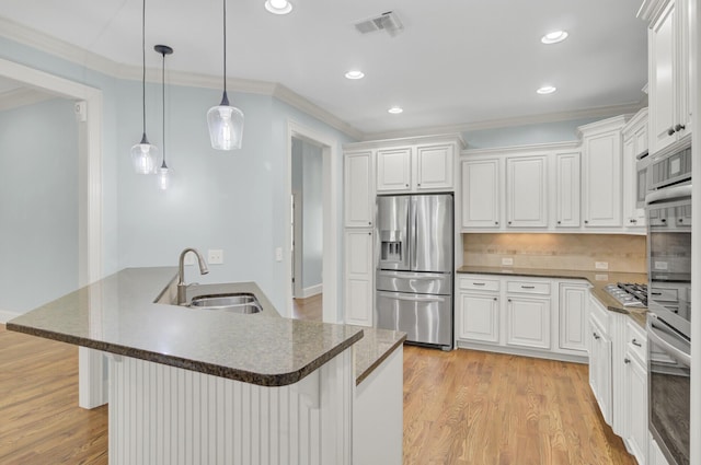 kitchen with visible vents, stainless steel appliances, light wood-type flooring, and a sink