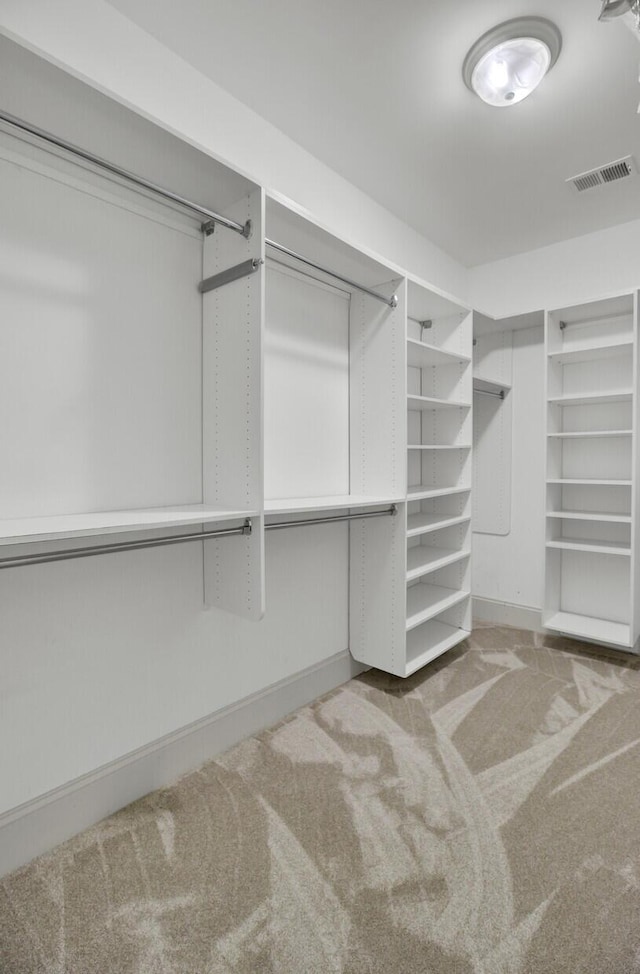 spacious closet featuring visible vents and carpet