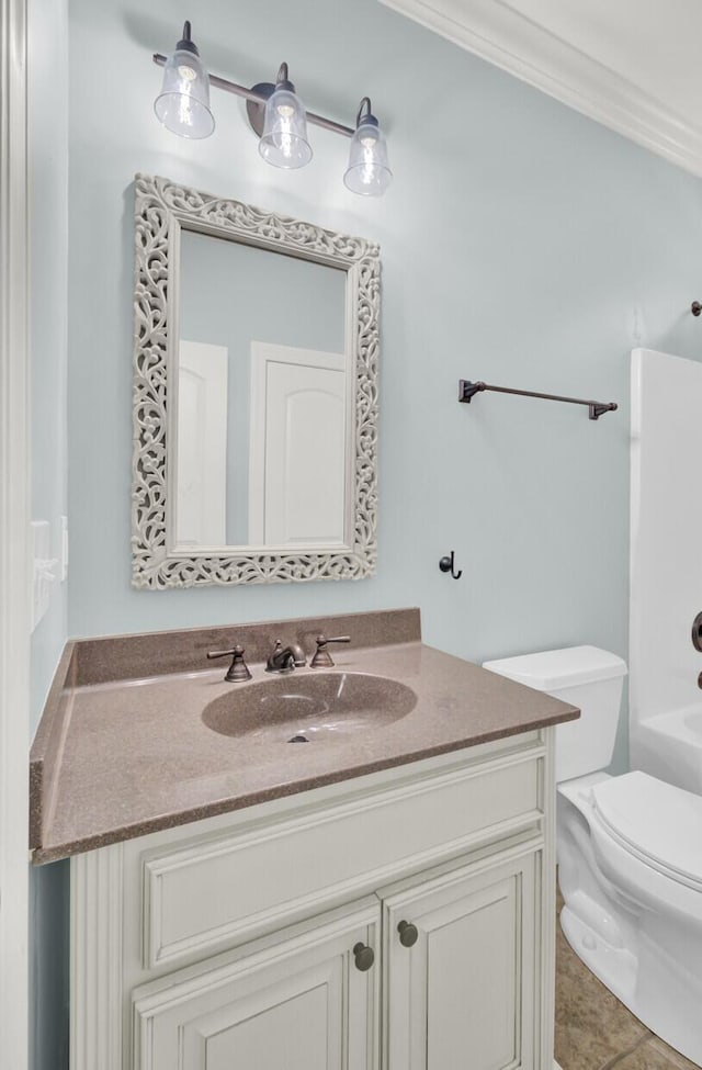 bathroom with tile patterned flooring, toilet, a washtub, and vanity