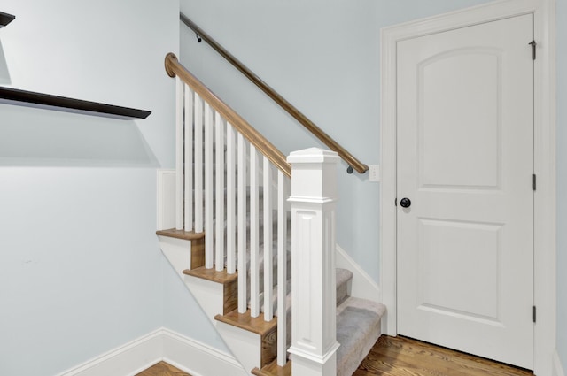 stairs featuring wood finished floors