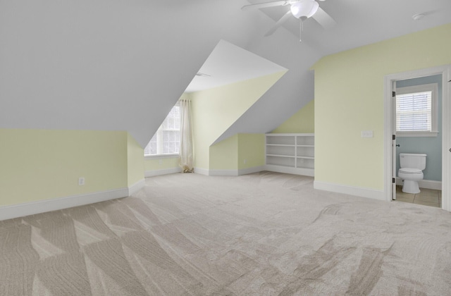 bonus room featuring baseboards, carpet, a ceiling fan, and vaulted ceiling