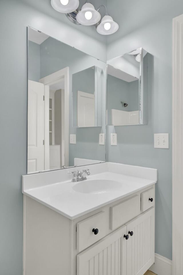 bathroom with vanity and baseboards