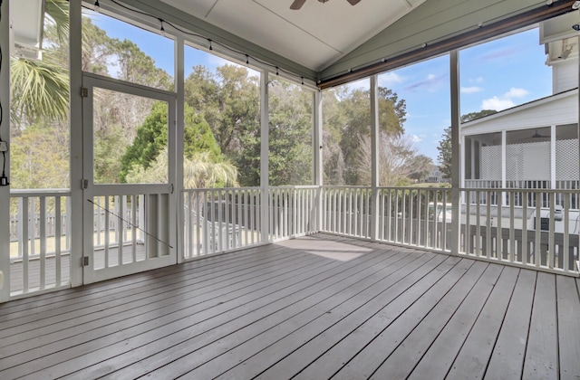 unfurnished sunroom featuring lofted ceiling and a ceiling fan