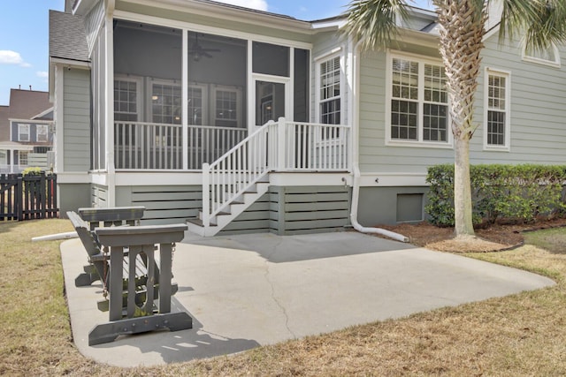 exterior space with a patio area, fence, roof with shingles, and a sunroom