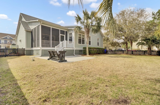 back of house with a patio area, a yard, a fenced backyard, and a sunroom