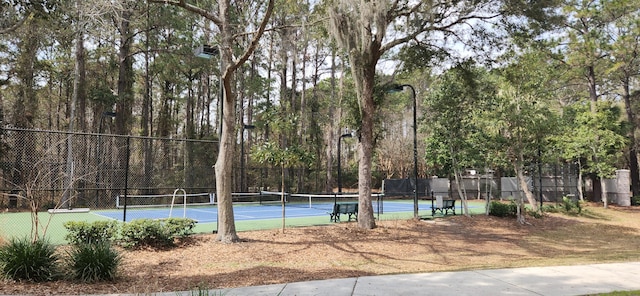 view of tennis court with fence