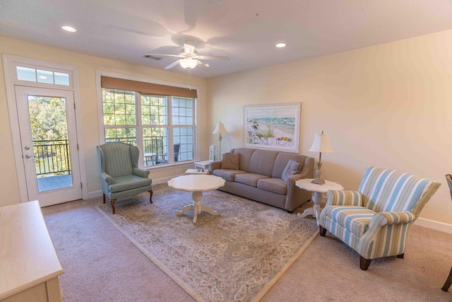 living room with ceiling fan and carpet floors