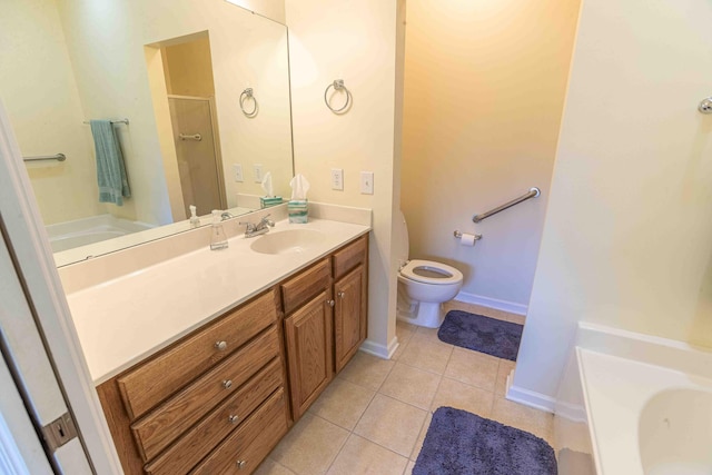 full bathroom featuring toilet, shower with separate bathtub, vanity, and tile patterned flooring