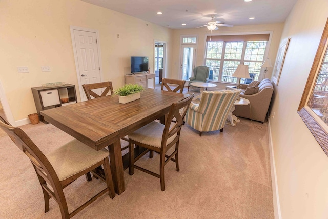 carpeted dining space featuring ceiling fan