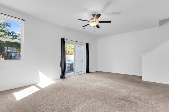 empty room with ceiling fan and light colored carpet