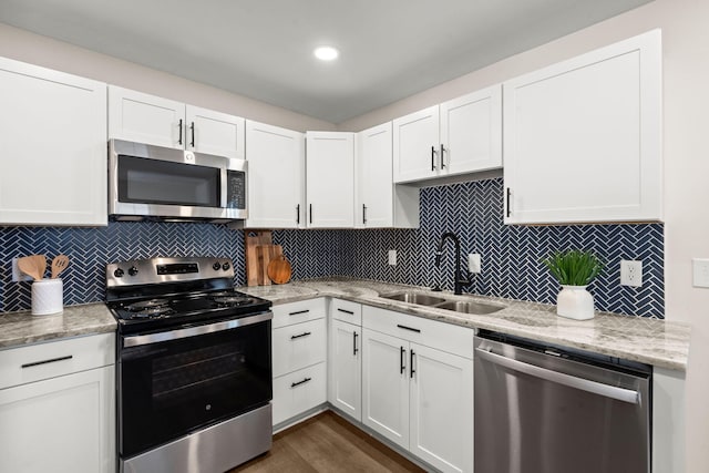 105 Bermuda Ct, Summerville, SC 29485 - kitchen with stainless steel appliances, a sink, white cabinets, and backsplash