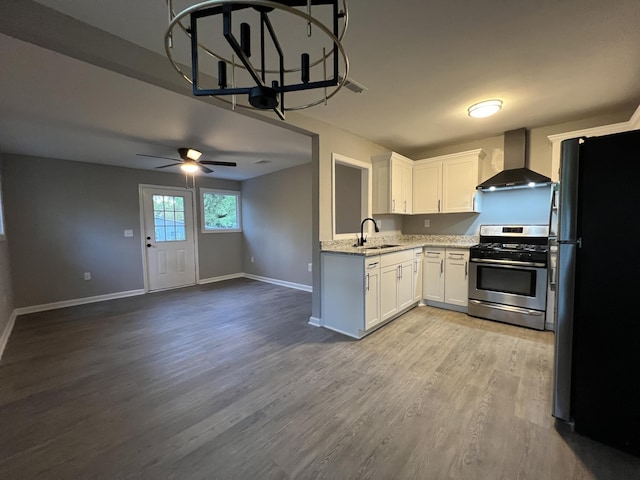 105 Bermuda Ct, Summerville, SC 29485 - kitchen with wall chimney exhaust hood, stainless steel range with gas cooktop, freestanding refrigerator, a sink, and ceiling fan