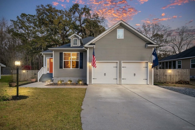 view of front of property featuring a front yard, fence, and driveway