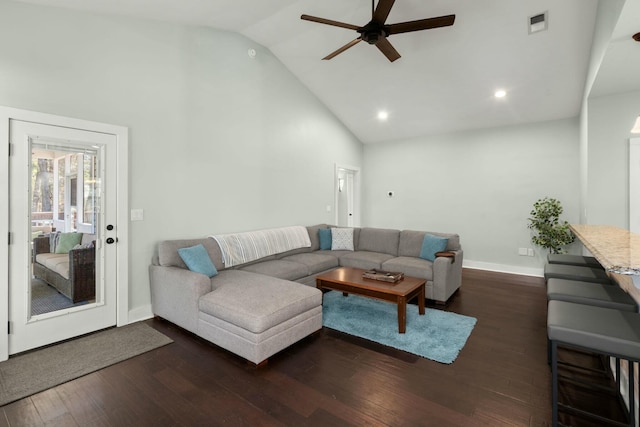 living room with visible vents, baseboards, dark wood finished floors, high vaulted ceiling, and a ceiling fan