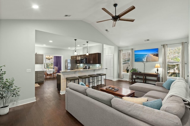 living room featuring ceiling fan, visible vents, baseboards, and dark wood-style floors