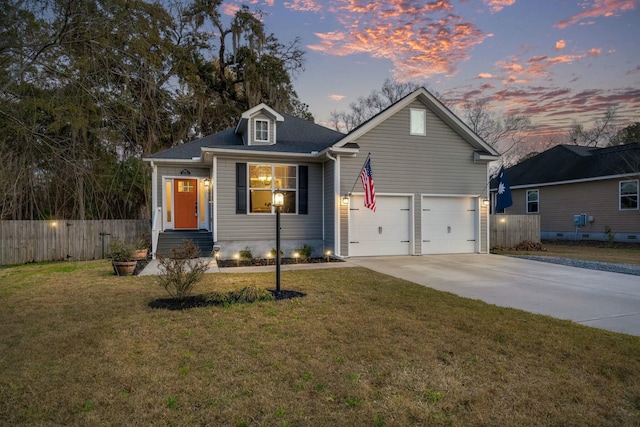 view of front of house featuring a yard, fence, a garage, and driveway