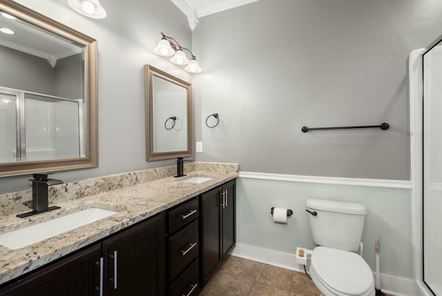 bathroom featuring tile patterned floors, toilet, crown molding, and a sink