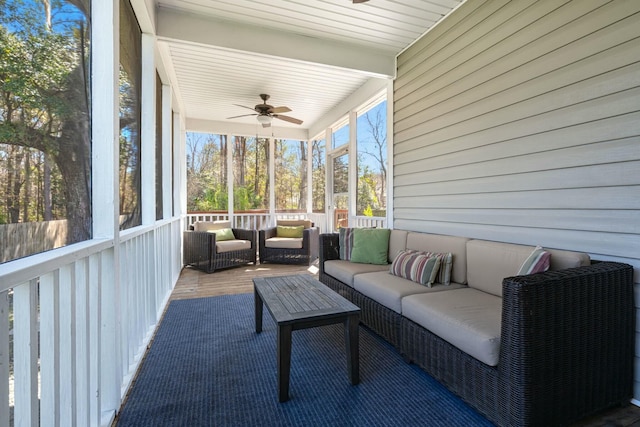 sunroom / solarium featuring ceiling fan