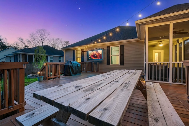 wooden terrace featuring grilling area and ceiling fan