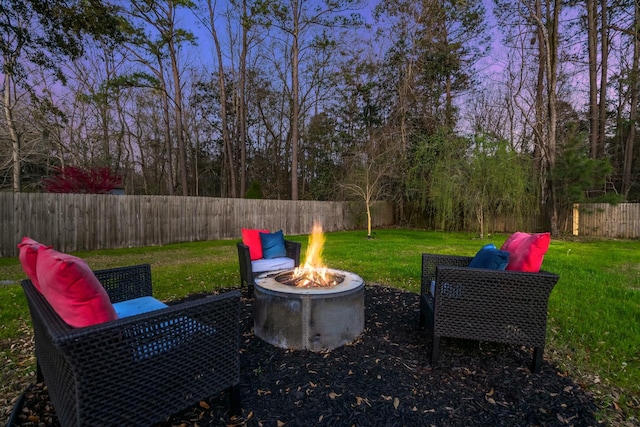 view of yard with a fire pit and a fenced backyard