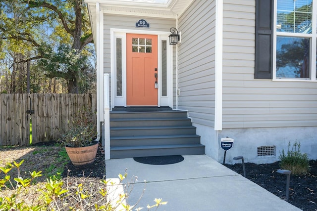 doorway to property with crawl space and fence