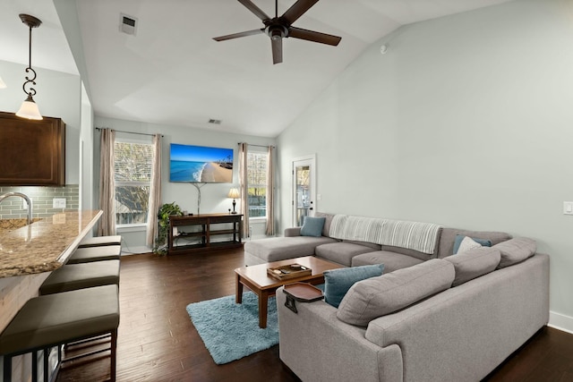 living area featuring visible vents, high vaulted ceiling, baseboards, ceiling fan, and dark wood-style flooring