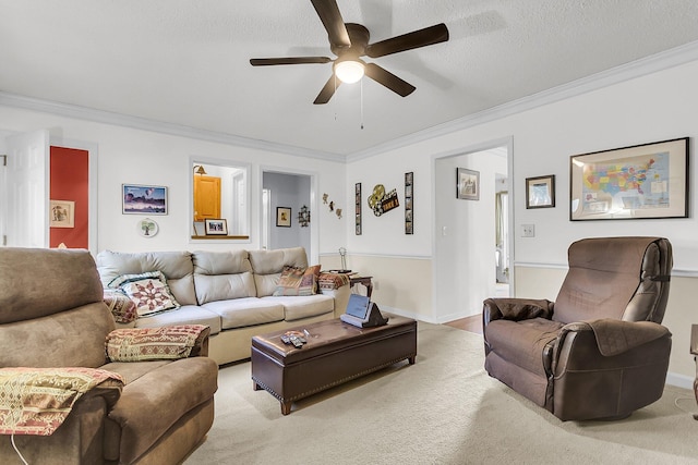 living room with ceiling fan, crown molding, and a textured ceiling