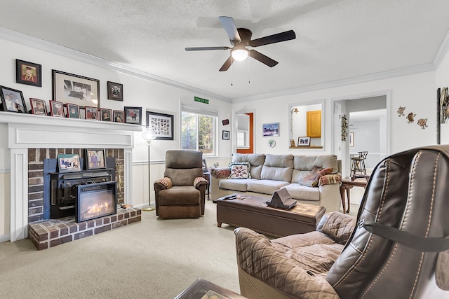 living room with carpet, a brick fireplace, ornamental molding, a textured ceiling, and ceiling fan