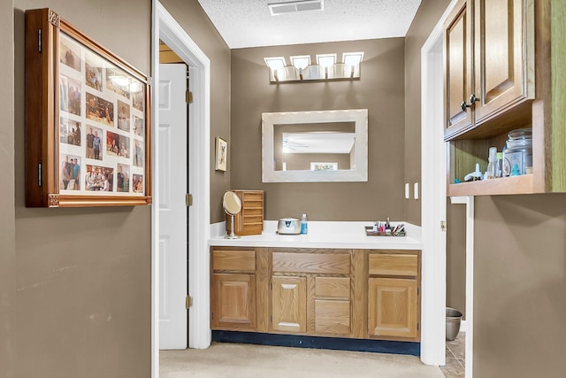 bathroom with vanity and a textured ceiling