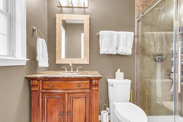 bathroom featuring vanity, toilet, and walk in shower