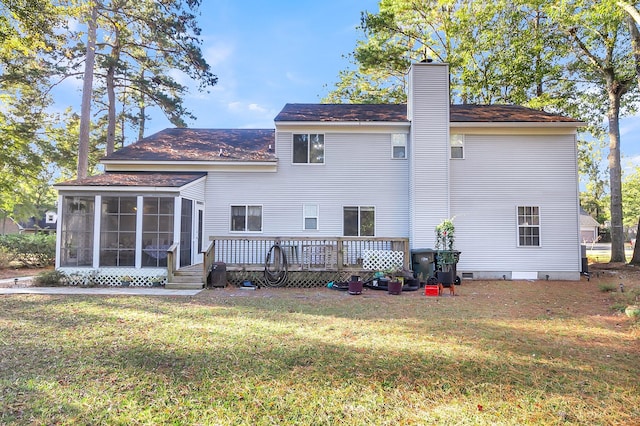 rear view of house featuring a yard, a deck, and a sunroom