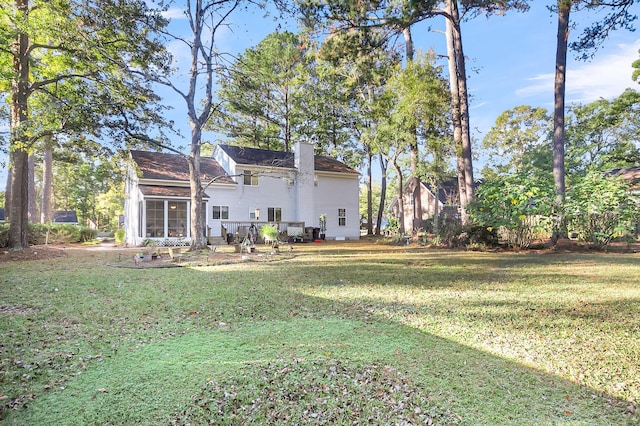 rear view of house with a lawn