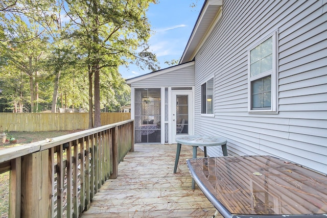 wooden deck featuring a sunroom