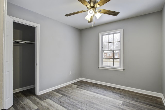 unfurnished bedroom featuring wood-type flooring, ceiling fan, and a closet