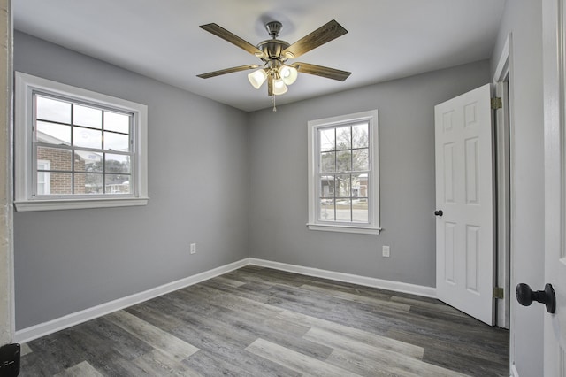 spare room featuring ceiling fan and dark hardwood / wood-style flooring