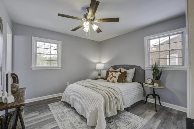 bedroom with dark wood-type flooring and ceiling fan