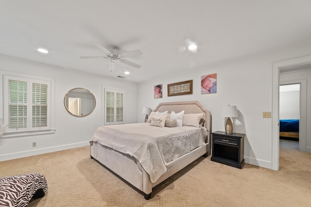 bedroom featuring ceiling fan, light carpet, and multiple windows