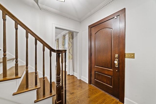 entryway featuring crown molding and hardwood / wood-style floors