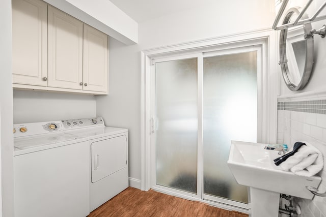 12 Port Tack, Hilton Head Island, SC 29928 - laundry room featuring cabinet space, separate washer and dryer, and light wood-style floors