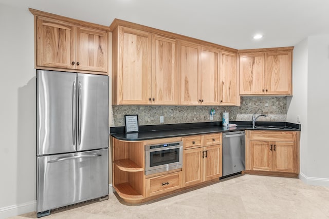 12 Port Tack, Hilton Head Island, SC 29928 - kitchen featuring stainless steel appliances, a sink, baseboards, dark countertops, and decorative backsplash