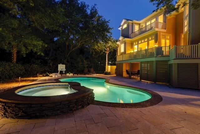 12 Port Tack, Hilton Head Island, SC 29928 - pool at night with a patio area and a pool with connected hot tub