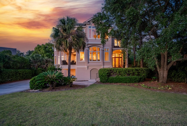 12 Port Tack, Hilton Head Island, SC 29928 - mediterranean / spanish-style home with a lawn, stucco siding, and driveway