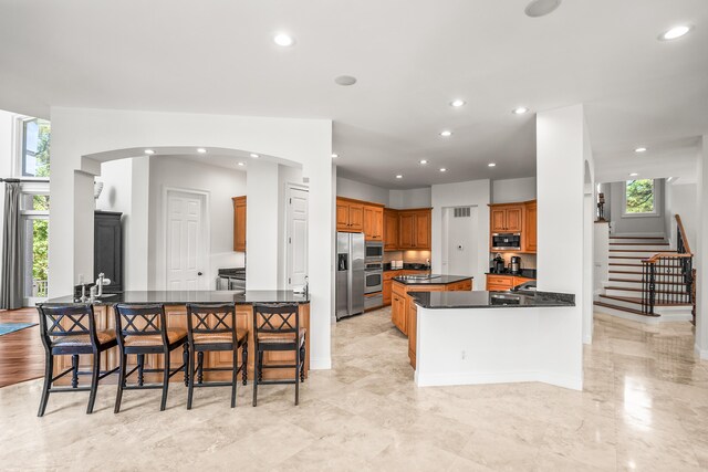 12 Port Tack, Hilton Head Island, SC 29928 - kitchen with stainless steel appliances, a spacious island, healthy amount of natural light, dark countertops, and recessed lighting