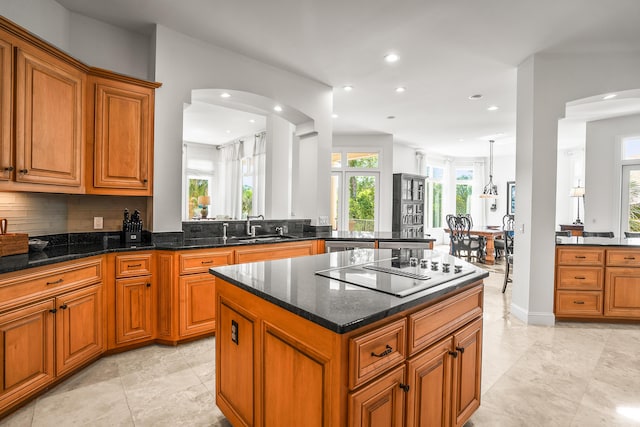 12 Port Tack, Hilton Head Island, SC 29928 - kitchen featuring black electric stovetop, brown cabinets, a sink, recessed lighting, and dark stone counters