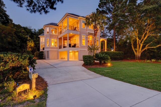 12 Port Tack, Hilton Head Island, SC 29928 - view of front facade featuring a balcony, an attached garage, driveway, and a front yard