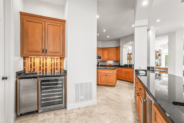 12 Port Tack, Hilton Head Island, SC 29928 - indoor bar featuring wine cooler, recessed lighting, arched walkways, and stainless steel refrigerator