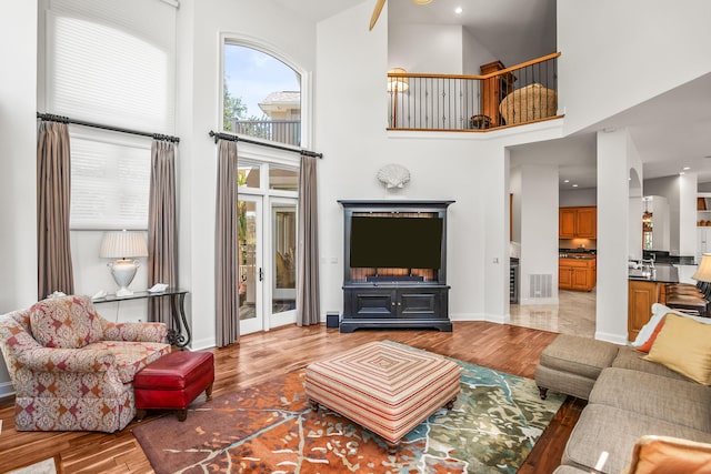 12 Port Tack, Hilton Head Island, SC 29928 - living room featuring wood finished floors, a towering ceiling, and baseboards