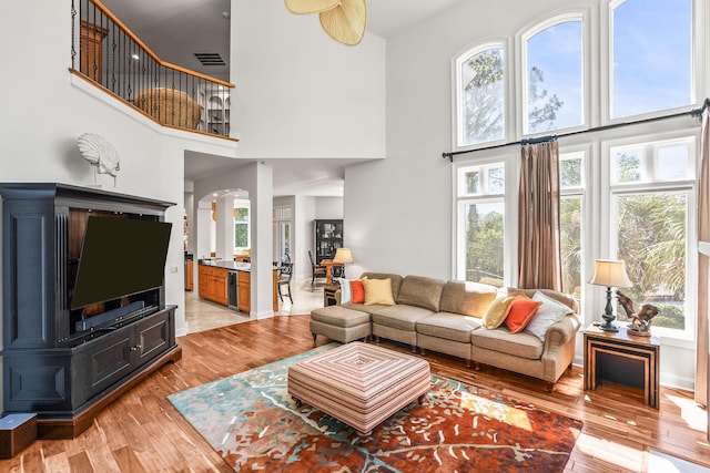12 Port Tack, Hilton Head Island, SC 29928 - living area with a towering ceiling, light wood-style floors, arched walkways, and baseboards