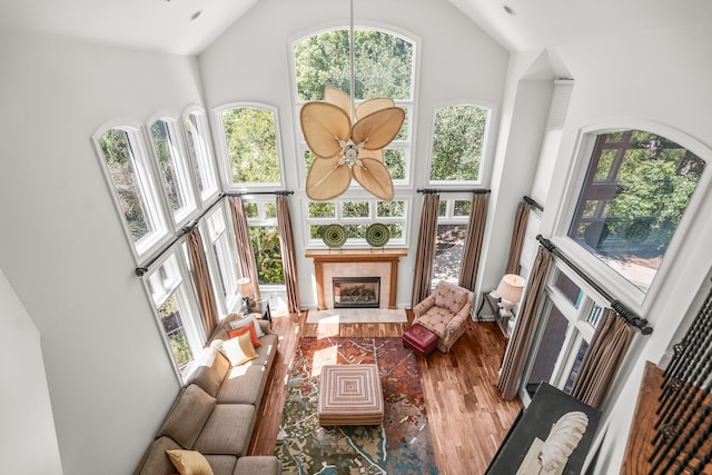 12 Port Tack, Hilton Head Island, SC 29928 - living area featuring high vaulted ceiling, wood finished floors, plenty of natural light, and a tiled fireplace